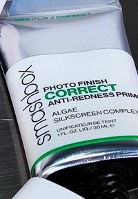 Smashbox Photo Finish Correct Anti-Redness Primer in a metallic tube with a green accent, featuring text and a black cap. 30 mL size.