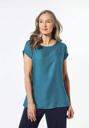 Top corto a maniche corte in teal con scollatura rotonda, caratterizzato da strass decorativi in un motivo a gradiente sulla parte anteriore. Tessuto morbido con una vestibilità rilassata.