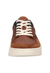 Brown leather and suede sneaker with a white sole, round toe, and perforated detailing. Features beige laces and a navy textile accent.