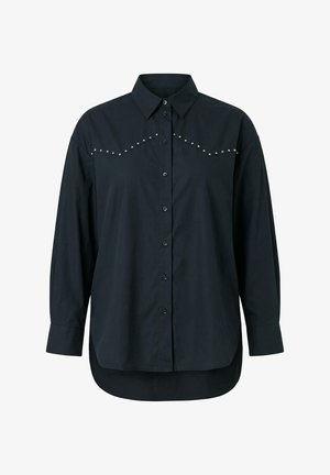 Černá košile s dlouhým rukávem na knoflíky, s špičatým límcem, stříbrnými cvočky přes hrudník a zakřiveným lemem, který je vzadu delší.