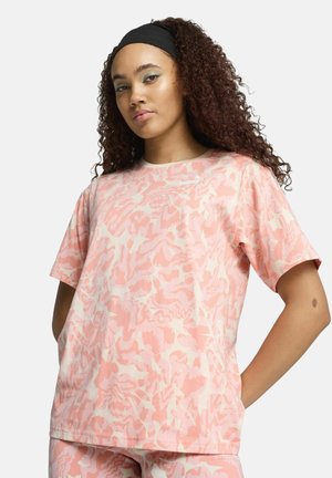 Short-sleeve t-shirt in light pink with a cream abstract pattern. Made of soft fabric, featuring a round neckline and relaxed fit.