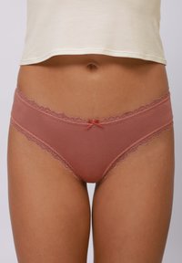 Lace-trimmed rose-hued underwear featuring a satin bow at the front. Soft, sheer mesh material offers a delicate appearance.