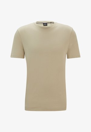 Beige puuvillane T-särk, millel on ümmargune kaelus, lühikesed varrukad ja õrn reljeefne logo rinna peal. Sile tekstuur, lihtne disain.