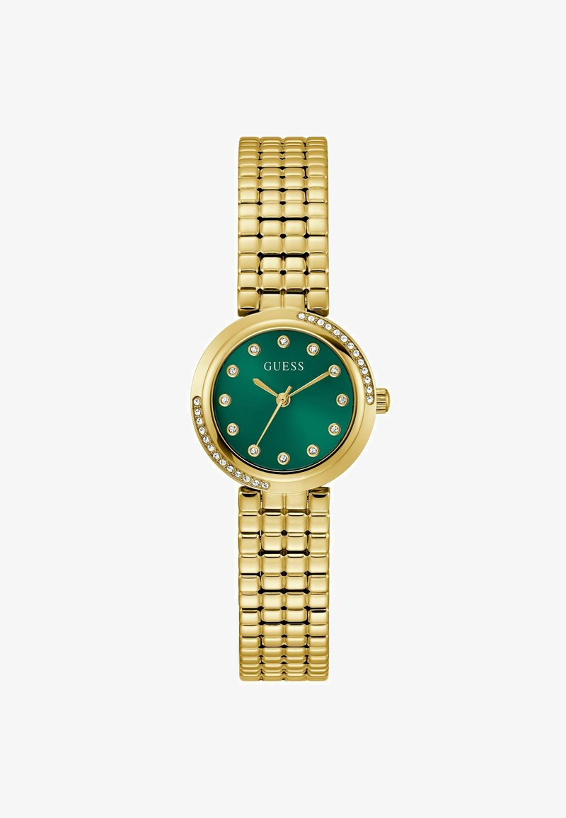 Reloj de pulsera en tono dorado con una esfera redonda verde, decorada con strass. La correa presenta un diseño flexible y texturizado. Nombre de la marca visible.