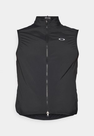 Must beeta kleiteta vest kerge kangast, kõrge krae ja ees oleva tõmblukuga, väikese logoga rinnal.