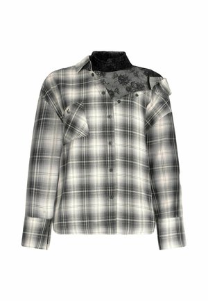 Camicia a quadri bianca e nera con un pizzo sulla spalla e dettagli sul colletto, presenta una vestibilità comoda, chiusure a bottoni e spalle scese.
