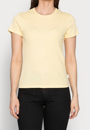 Żółta koszulka z krótkim rękawem, okrągłym dekoltem i dopasowanym krojem, wykonana z miękkiej bawełnianej tkaniny. Brak widocznego wzoru lub akcentów.