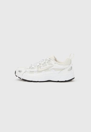 Άσπρο αθλητικό παπούτσι κατασκευασμένο από δίχτυ και συνθετικά υλικά. Διαθέτει υφή στην πάνω μεριά, μαλακή σόλα και αντίθετη μαύρη εξωτερική σόλα.