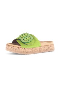 Groene suède slide sandalen hebben een dikke kurken zool en een grote, glanzende groene gespaccent op de bovenkant voor extra detail en textuur.