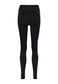 Svarta leggings med hög midja, tillverkade av elastiskt tyg. Har texturerade paneler längs sidorna och diskret logotyp vid midjan.