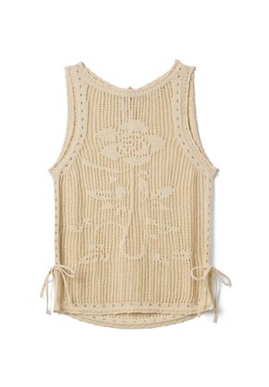 Top beige sin mangas de punto crochet con un patrón floral en el centro y cordones laterales atados en el dobladillo.