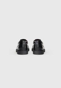 Black leather shoes with crocodile texture, rounded toe, rubber sole, and low heel. Back view shows seam details and stitching accents.