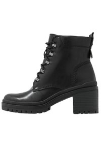 Musta nahkaiset nilkkurit, joissa on tukeva paksu korko, nauhoitettu etuosa ja teksturoidut sivut. Varustettu kestävällä pohjalla ja tikatuilla yksityiskohdilla.