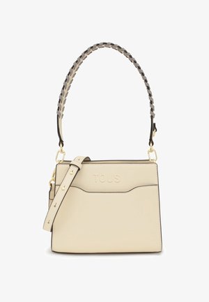 Sac à main en cuir texturé beige avec une anse tressée, matériel doré et logo "TOUS" en relief. Comprend une bandoulière amovible.