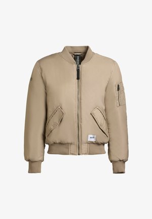 Chaqueta bomber beige con cierre de cremallera frontal, puños acanalados, dos bolsillos frontales inclinados y un pequeño bolsillo en el brazo. Fabricada con un material suave y acolchado.