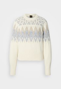 Sweater de malha creme com punhos e bainha canelados, apresentando padrões geométricos azuis e bege no peito e parte superior das mangas.