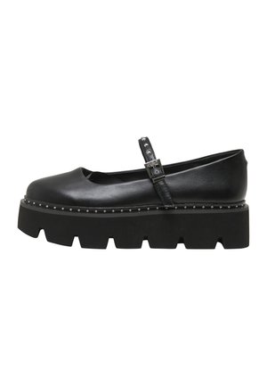 Chaussure Mary Jane noire avec semelle épaisse à crampons, garniture cloutée et bride à boucle ajustable sur le cou-de-pied, vue de côté.