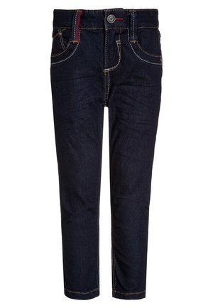 Ciemnoniebieskie dżinsy z żółtym szwem, pięcioma kieszeniami, zapięciem na guzik i lekko zwężanym krojem nogawek. Posiadają czerwony akcent w pasie.