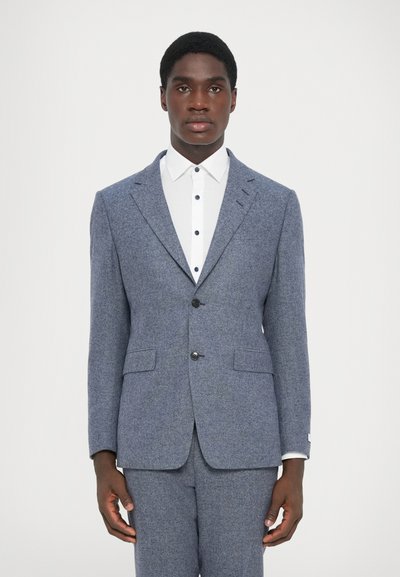 Blue textured suit with a notched lapel, two-button front, and two pockets. White shirt featuring dark buttons visible underneath the jacket.