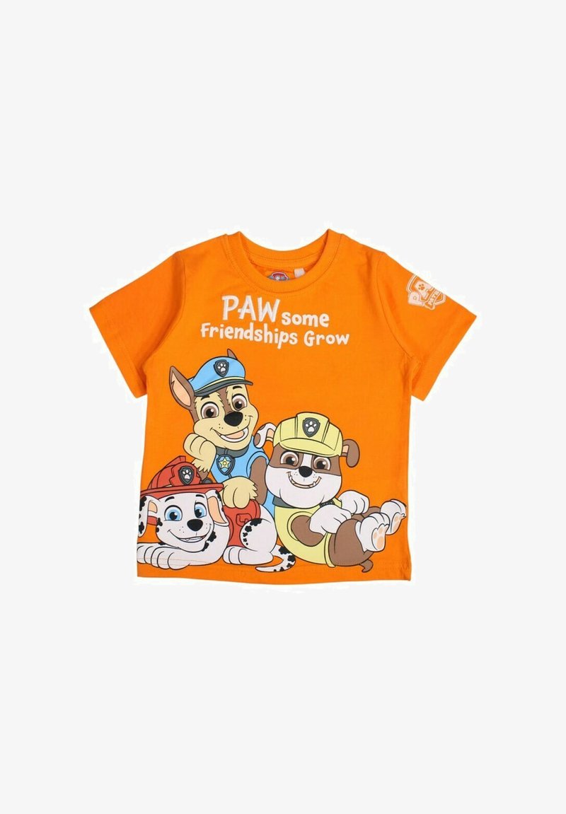 T-shirt en coton orange avec des chiens de dessin animé. Le texte dit "Des amitiés PATTES de plus en plus fortes." Comprend des personnages de couleurs et de détails variés.
