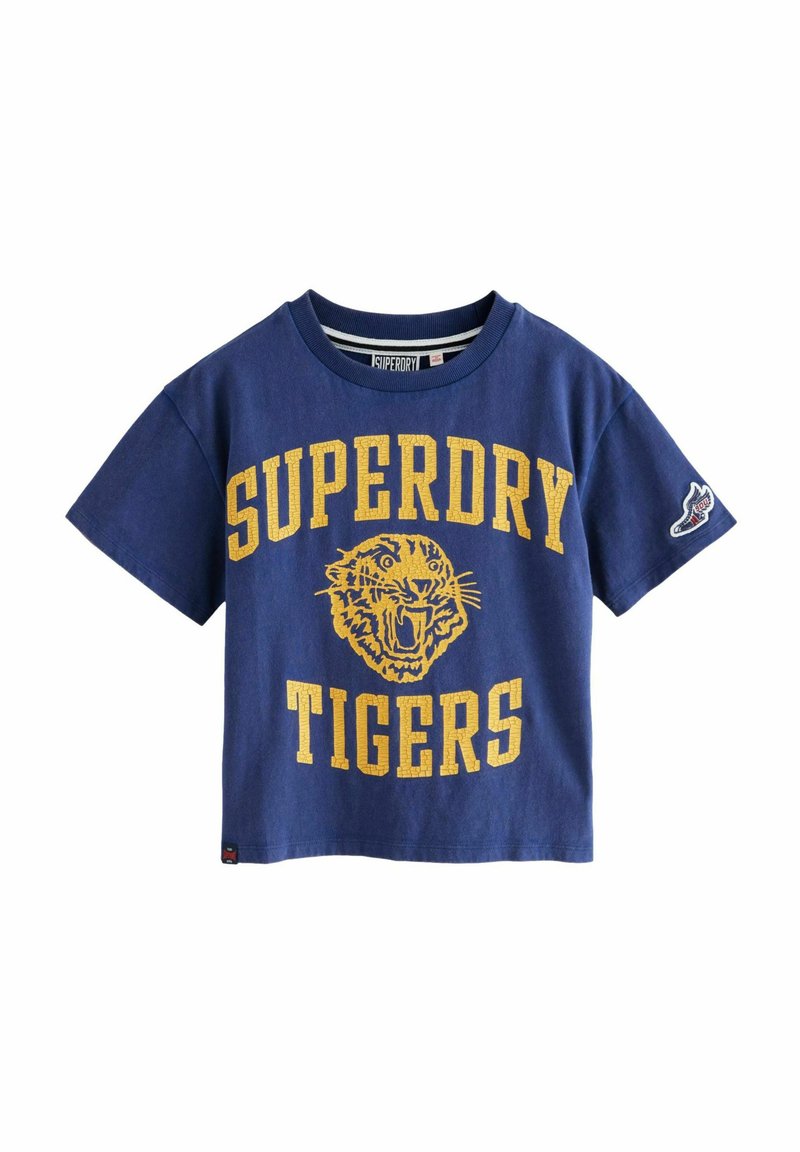Jūras zila kokvilnas T-kreklu ar īsām piedurknēm, ar dzelteno tekstu "SUPERDRY TIGERS" un tigras grafiku. Apaļa kakla izgriezums, brīvs piegriezums.