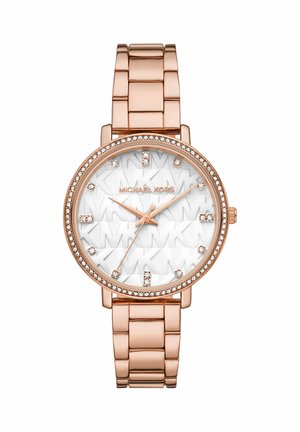 Rose gold metal watch with a round face, silver accents, embossed "MK" pattern, and diamond-like hour markers. Crystal embellishment surrounds the bezel.