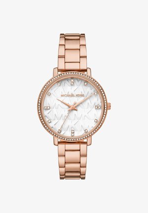 Rose gold metal watch with a round face, silver accents, embossed "MK" pattern, and diamond-like hour markers. Crystal embellishment surrounds the bezel.