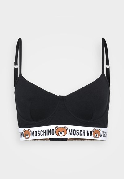 Crni pamukasti bralette s tankim podesivim trakama, s bijelom elastičnom trakom s logotipom medvjedića i tekstom "MOSCHINO" pri dnu.