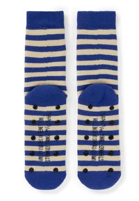 Coppia di calzini a righe blu e beige con grip antiscivolo neri sulle suole, mostrati stesi con le suole rivolte verso l'alto.