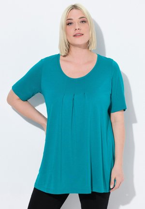 Top corto teal con maniche corte e scollo rotondo, caratterizzato da pieghe sul davanti e una vestibilità morbida. Realizzato in un tessuto leggero e morbido.