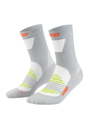 Compression socks in light grey with orange and neon green accents. Features horizontal stripes and a snug fit for support and comfort.