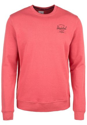 Sudadera de color rosa coral de manga larga con cuello redondo, puños y dobladillo acanalados, con pequeño logo negro "Herschel" en la parte superior izquierda del pecho.