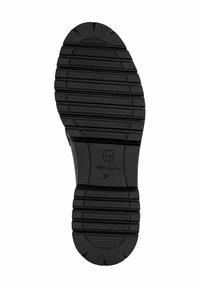 Black rubber shoe sole with textured grooves and ridges. Features a central logo and size 37 indicated on the upper section.