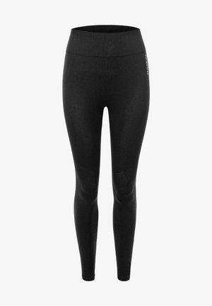 Czarne legginsy z wysokim stanem, gładką fakturą i siateczkowymi akcentami na dolnych nogawkach. Zaprojektowane z myślą o elastyczności i komforcie.