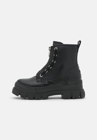 Stivaletti neri alla caviglia in pelle testurizzata con suola in gomma chunky, chiusura con zip e design con lacci caratterizzato da occhielli argentati.