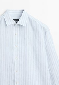 Light blue and white vertical striped long-sleeve shirt with buttons and a pointed collar, partially visible on a white background.