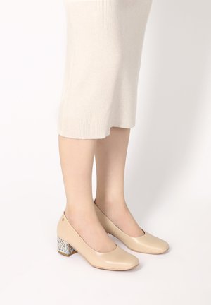 Beige leather ballet pumps with a square toe and decorative blue patterned block heel. Smooth finish, low heel height, minimalistic design.