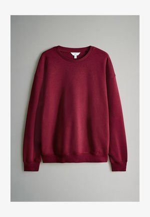 Bordeaux sweatshirt met een ronde hals, lange mouwen en ribgebreide manchetten, gemaakt van zachte stof met een gladde textuur.