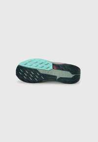 Nike trail running shoe sole, featuring a black rubber tread, mint green midsole, and textured grey upper with pink accents and branding.