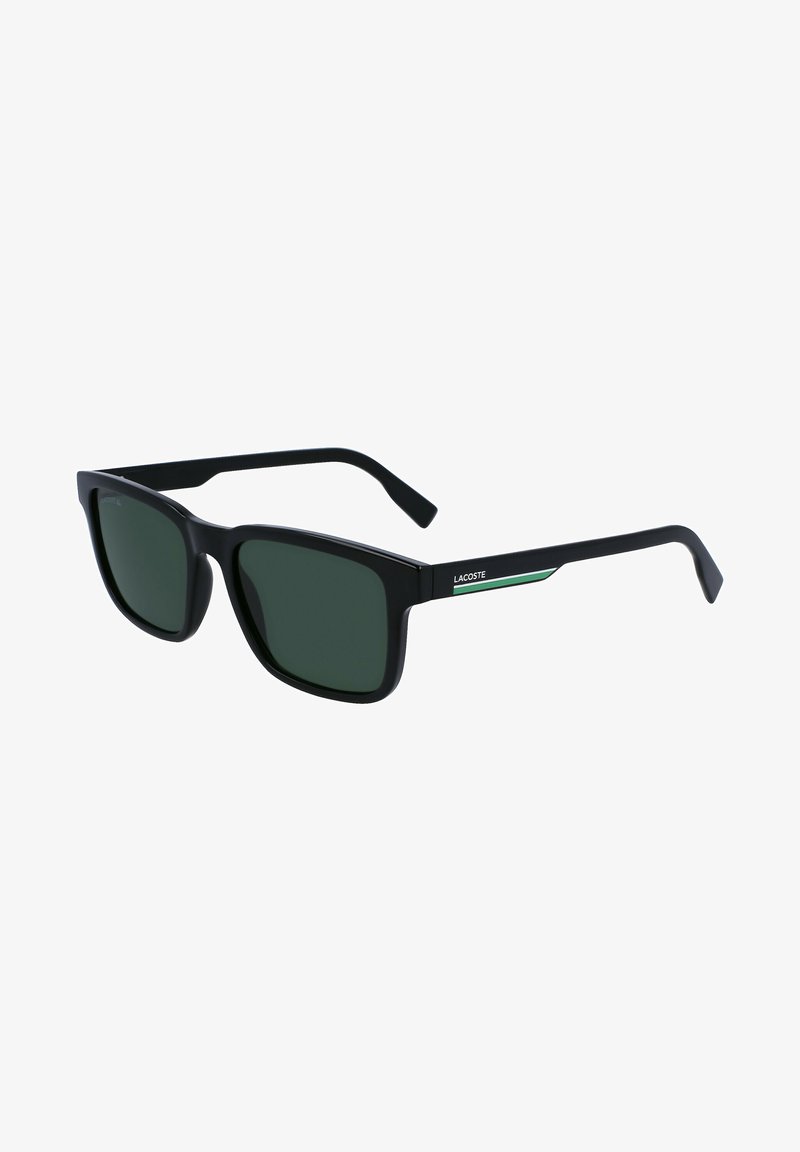 Black sunglasses with green tinted lenses, square shape, matte finish, featuring a subtle green accent on the side, embossed logo on the frame.