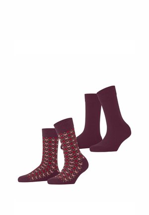 Due paia di calzini a metà polpaccio, uno viola scuro tinta unita e uno con motivo a rombi rosso e beige su sfondo viola.