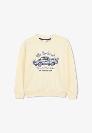 Sweat-shirt jaune avec un graphisme d'un camion avec des planches de surf, le mot "Timberland" et un slogan. Confectionné en tissu doux avec des poignets côtelés.