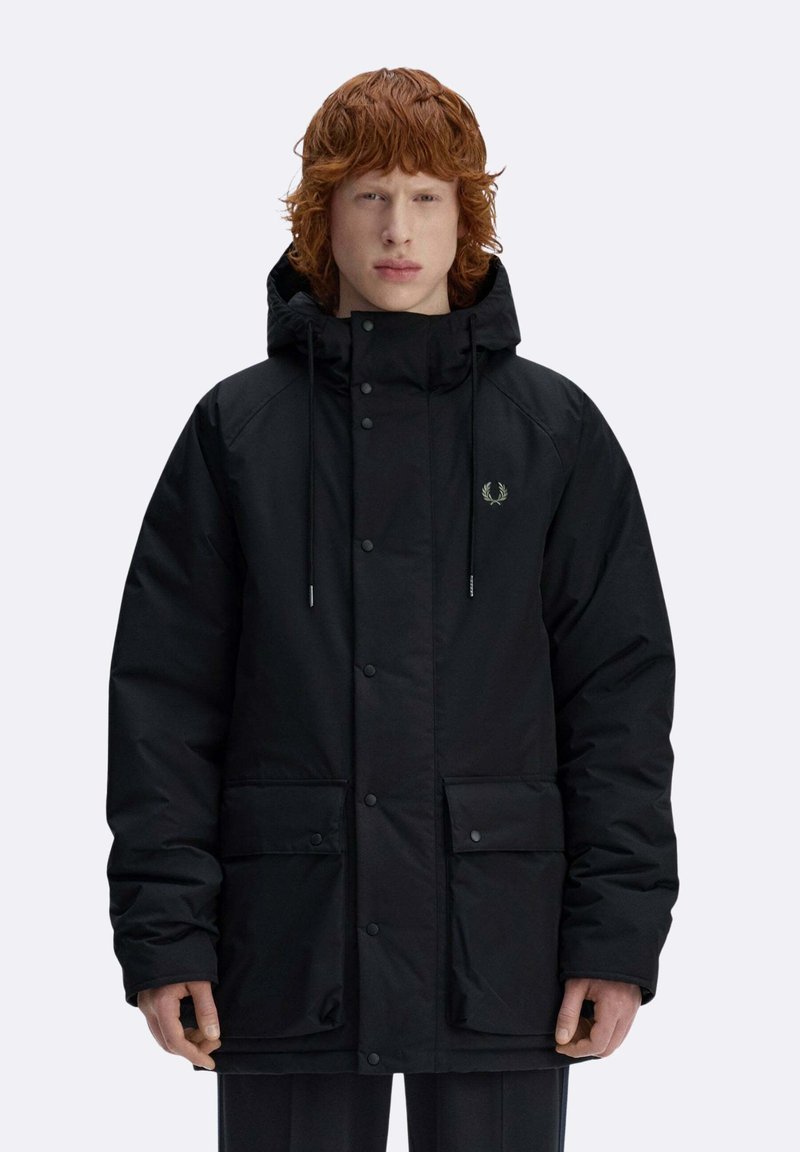 Giacca imbottita nera con cappuccio, chiusura a bottoni a pressione, due tasche frontali e un logo discreto sul petto. Tessuto dalla texture morbida.