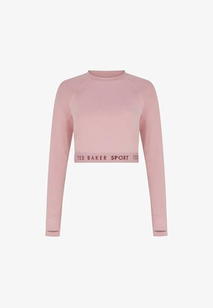 Heled roosa lühikeste varrukatega sportlik topp, millel on raglanvarrukad. Alumises servas on dekoratiivne riba, millel on tekst "TED BAKER SPORT".