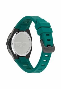 Reloj Aston Martin con caja negra y correa de silicona en color verde azulado. Presenta una parte trasera de metal suave con el logo de Aston Martin y una correa texturizada.