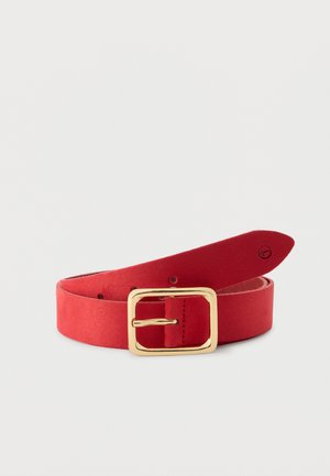 Red suede belt with a large rectangular gold buckle, rolled with visible adjustment holes on a plain light background.