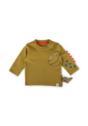 Olivgrünes Langarm-Kinderhemd mit Dinosauriergesicht vorne, blauen Punkten und roten Stacheln an einem Ärmel sowie einem kleinen Dinosaurierspielzeug.
