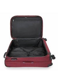Red fabric suitcase with a zippered opening, a black interior, and a mesh pocket. Features include handles and wheels for mobility.