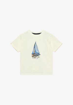 T-shirt crème avec un motif de voilier en bleu et marron, manches courtes et col rond. Texture en coton lisse.