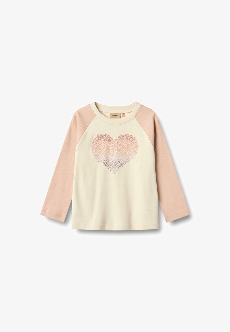 Camisa de manga larga en crema y rosa claro con un gráfico de corazón hecho de pequeños puntos. Material de algodón, cuello redondo y mangas raglán.